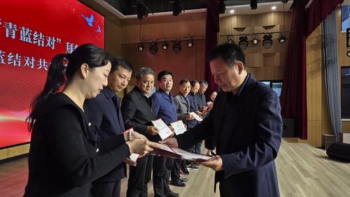 2学校党委书记周卫红向指导教师颁发聘书